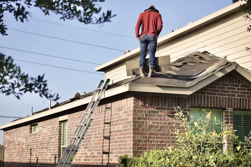 Professional roofer working on a residential roof in Woodside Estates
